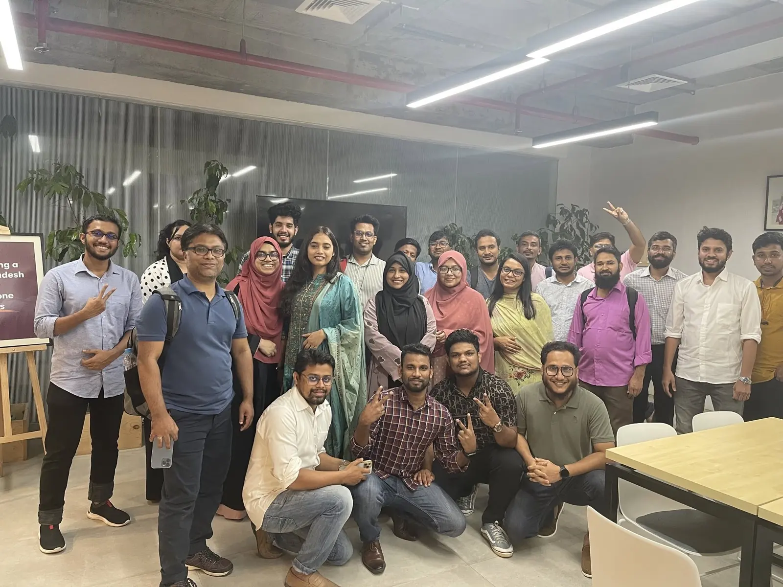 The entire Cloud Production team, around twenty-five colleagues, posing together in the company's open-plan office